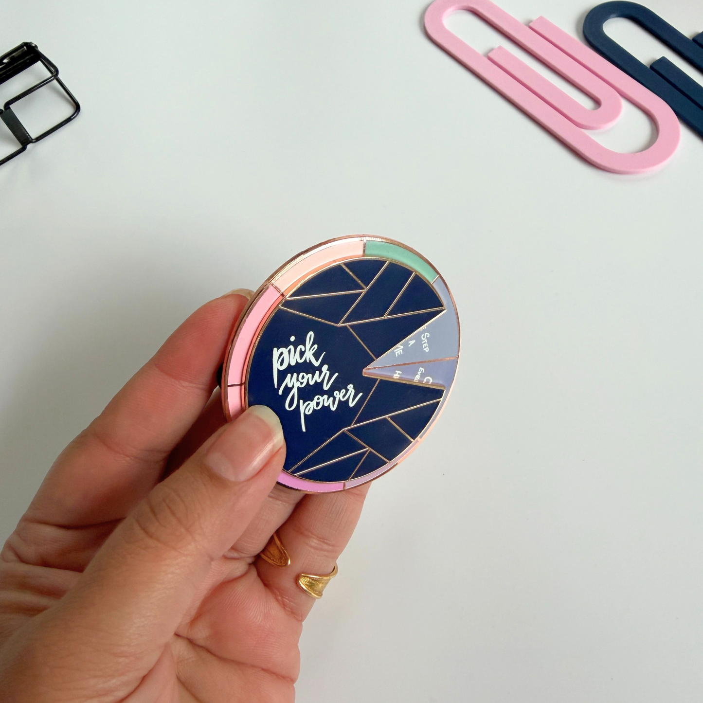 Motivational enamel fidget pin with rotating spinner design – inspirational accessory for daily creativity.