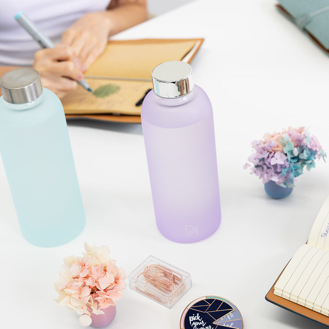 Frosty glass water bottle with wide mouth opening for easy cleaning and ice cubes