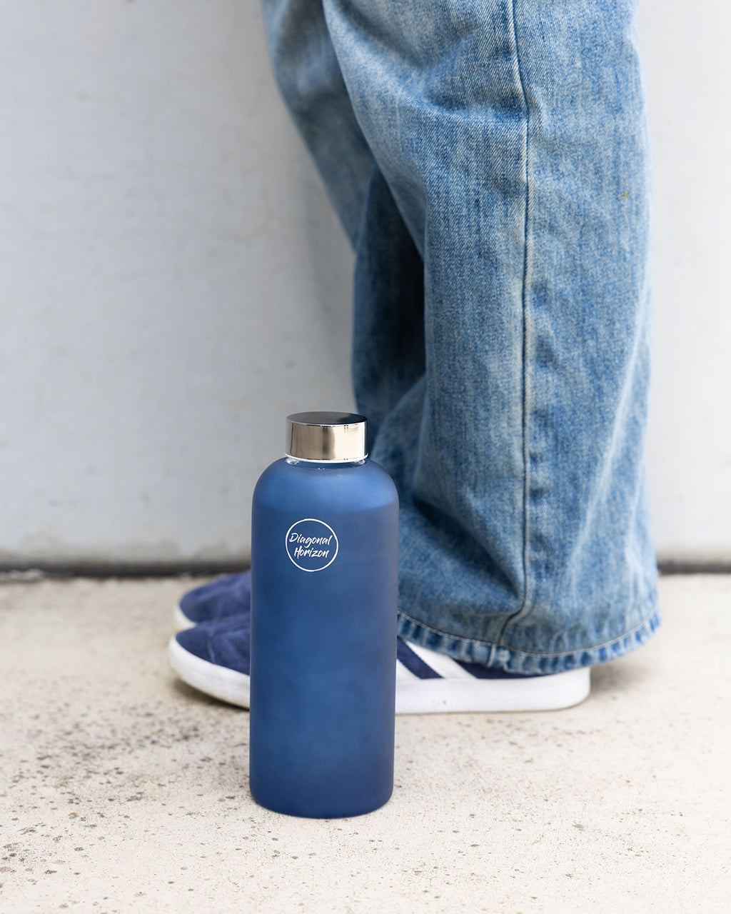 Blue frosted glass water bottle perfect hydration tool.