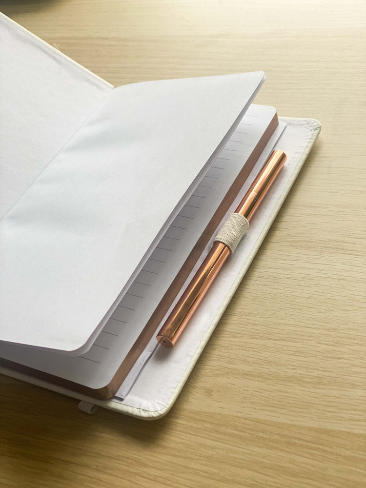 White Notebook with metallic Rose gold edges with pen holder